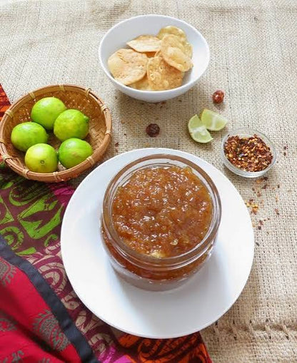 Homemade nimbu ki chutney (lemon chutney) in a bowl with fresh lemons